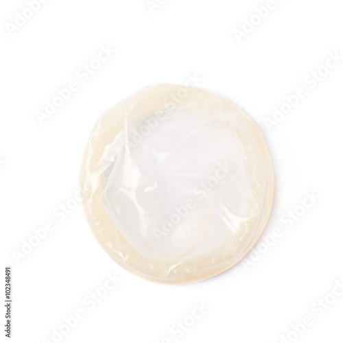 Rolled latex condom isolated