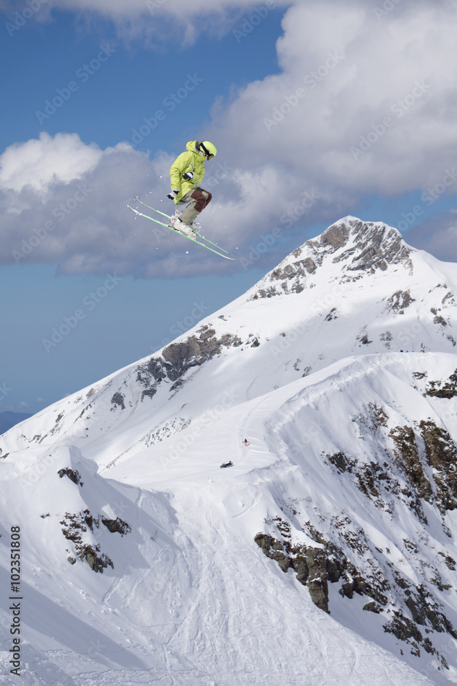 Flying skier on mountains. Extreme sport.