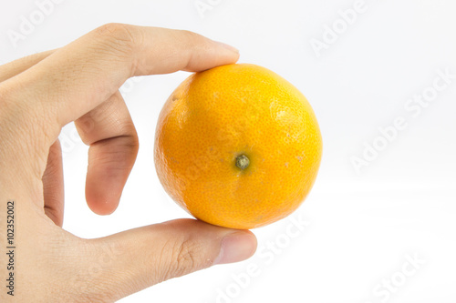 Orange in a hand isolated on white background