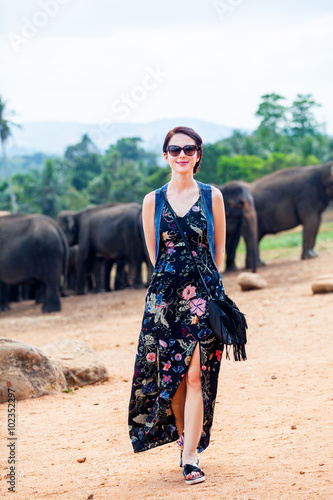 Young woman and wild elephants