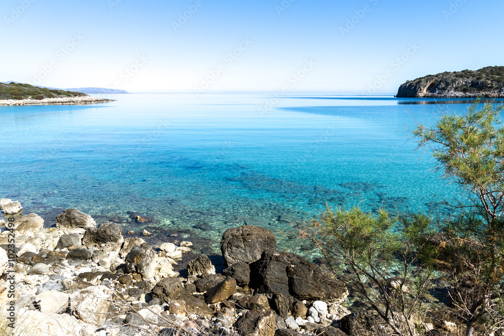 Beautiful idyllic turquoise waters coast with pebbles and rocks. Beautiful idyllic turquoise waters coast with pebbles and rocks.
