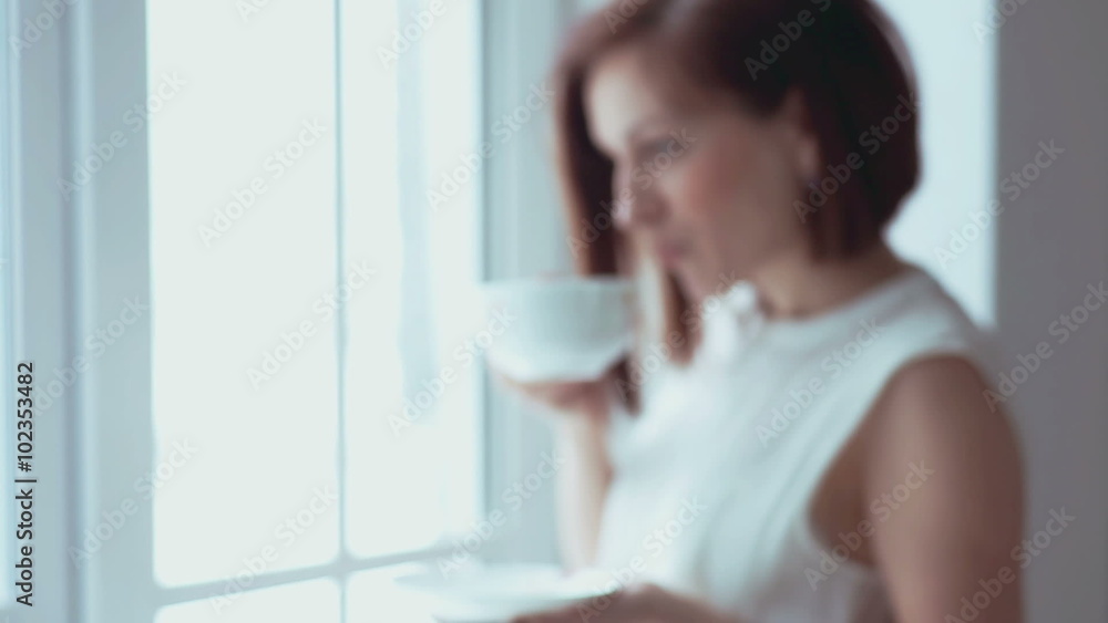 Drinking tea at the window Drinking tea at the window