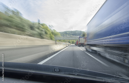 Car that overtake a truck in freeway