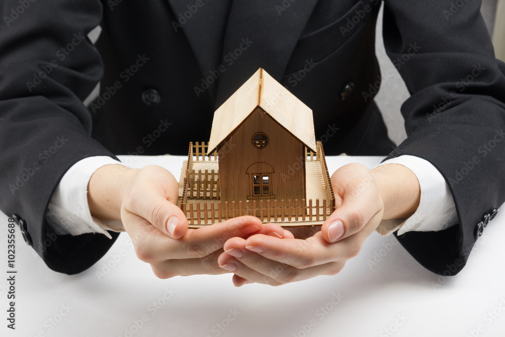 Hands holding small model of house. Real estate concept Stock Photo