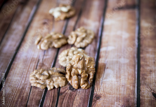 Walnut kernels on rustic old wooden table, shallow depth of field