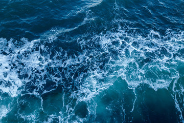 Blue sea texture with waves and foam