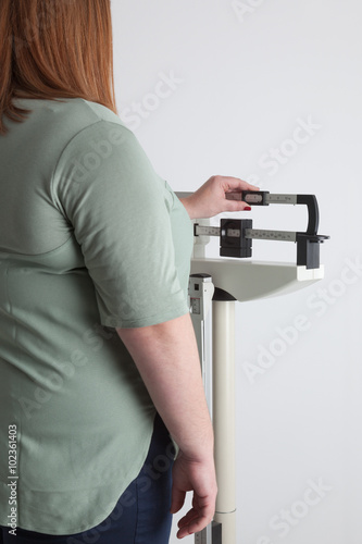 фотографія overweight woman on a medical weight scale