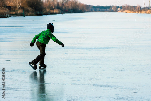 A boy skating on the frozen lake