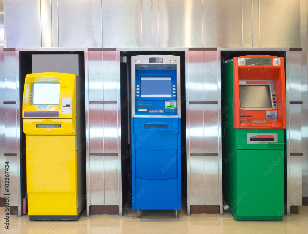 Three different atm machine againt aluminum wall Three different atm machine againt aluminum wall