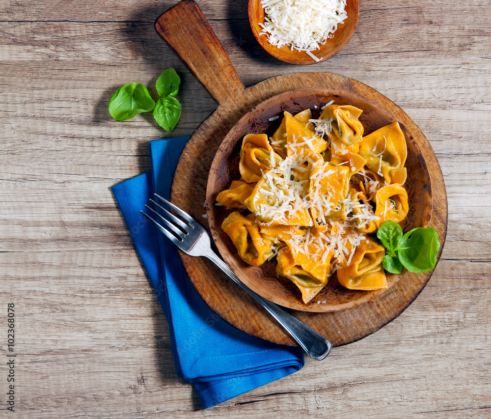 with chili peppers on a wooden table. Rustic style.filled pasta with chili peppers on a wooden table. Rustic style.filled pasta