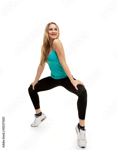 young woman with slim body. squatting on tiptoes