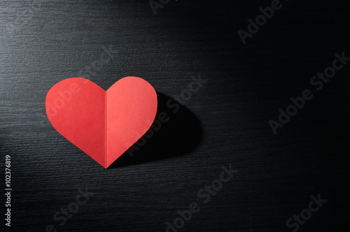 red hearts isolated on dark wood background