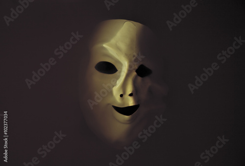 Deformed scary mask in the dark water 