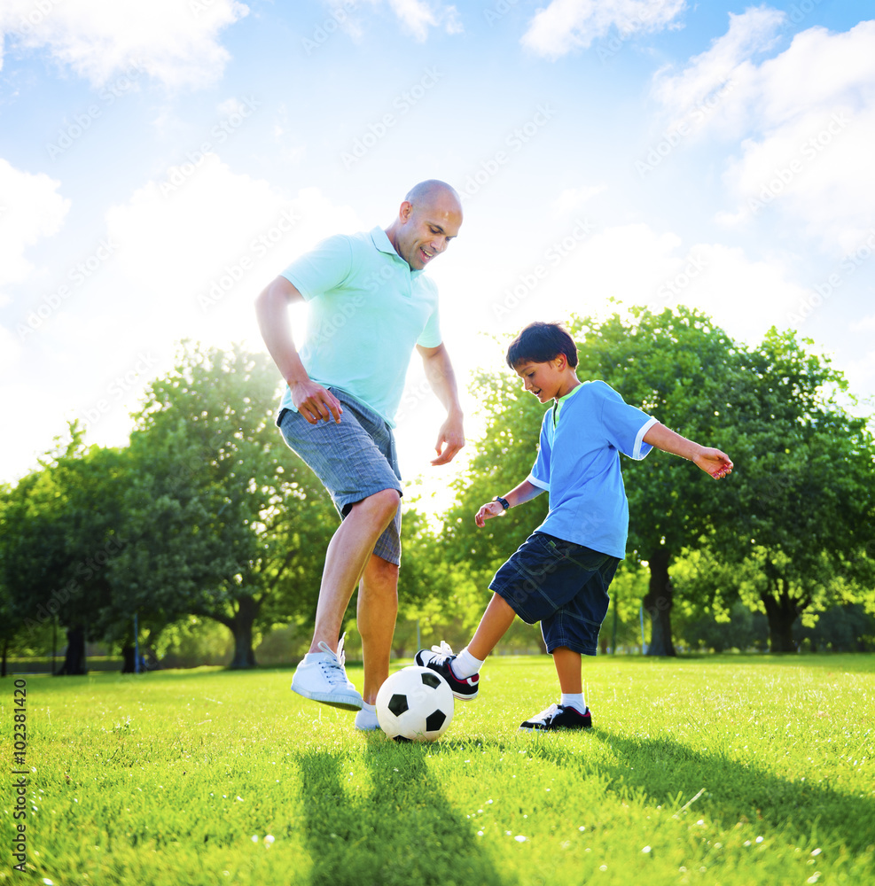 Little Boy Playing Soccer With His Father Concept Little Boy Playing Soccer With His Father Concept
