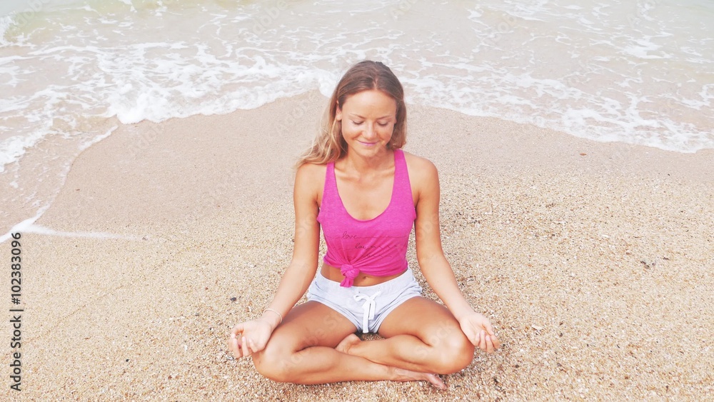Woman doing meditation near the ocean beach. Yoga silhouette. Woman doing meditation near the ocean beach. Yoga silhouette.