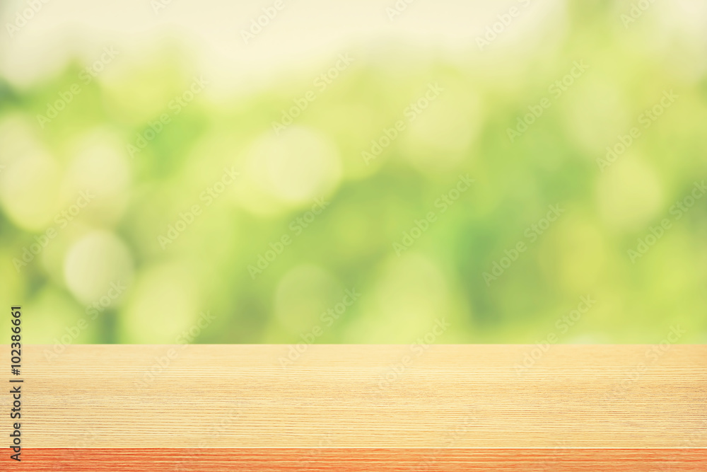 Wood table top on green bokeh abstract background, soft tone Wood table top on green bokeh abstract background, soft tone