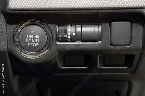 close up of engine start switch and multiple function control by button in sport car. © ImagineDesign