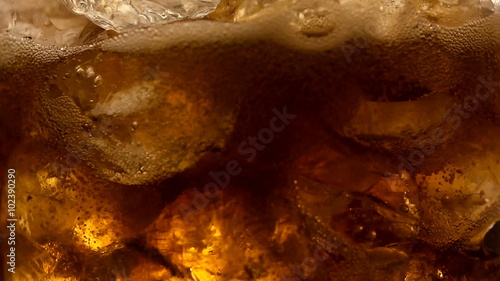 Refreshing Brown Soda with Ice cubes and bubbles
