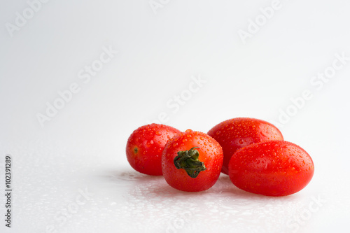  fresh Tomatoes with drops isolated on white background