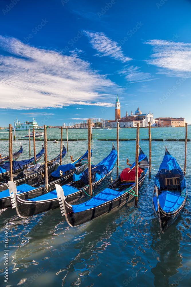 Venice with gondolas on Grand Canal against San Giorgio Maggiore church in Italy