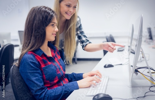 Smiling students using computer 