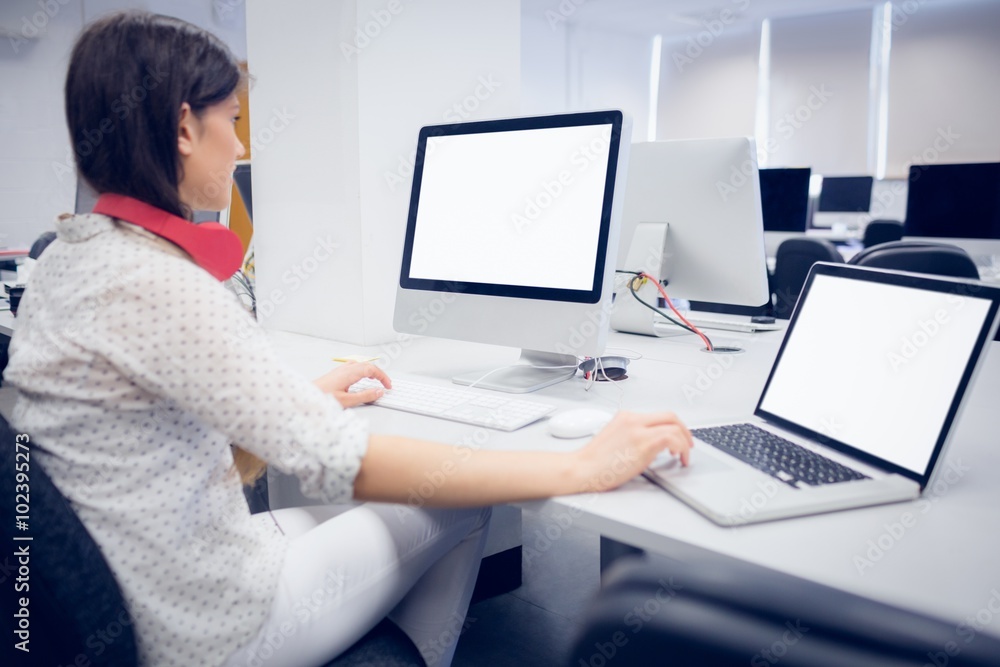 Rear view of student using computer 