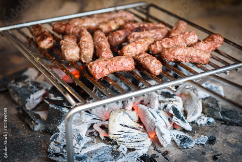 Grilling Meat on barbecue grill with coal.