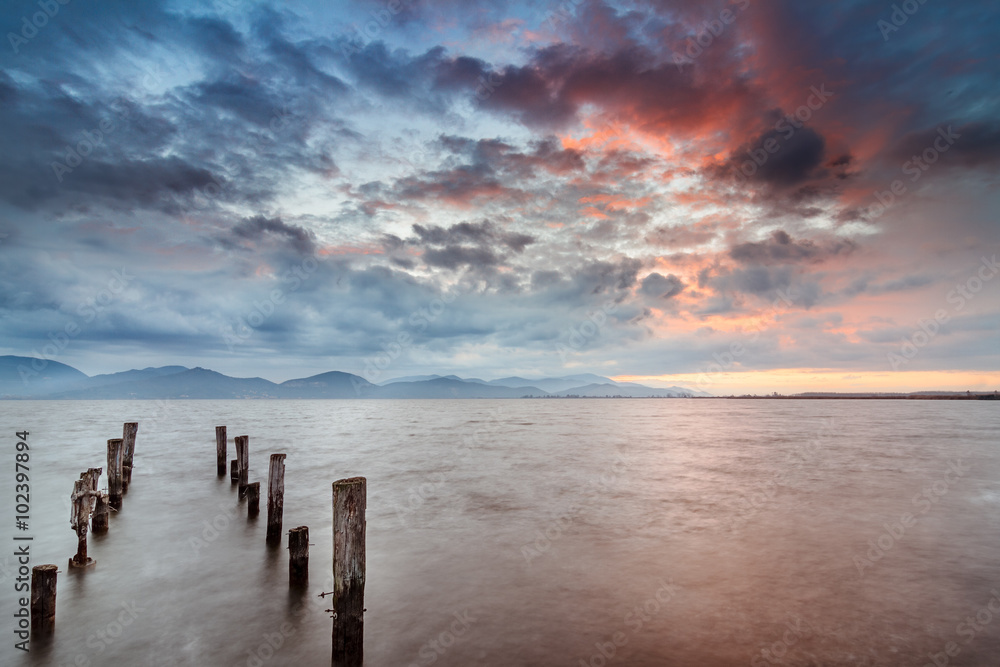 Old abandoned pier. Long exposure at sunrise. Old abandoned pier. Long exposure at sunrise.