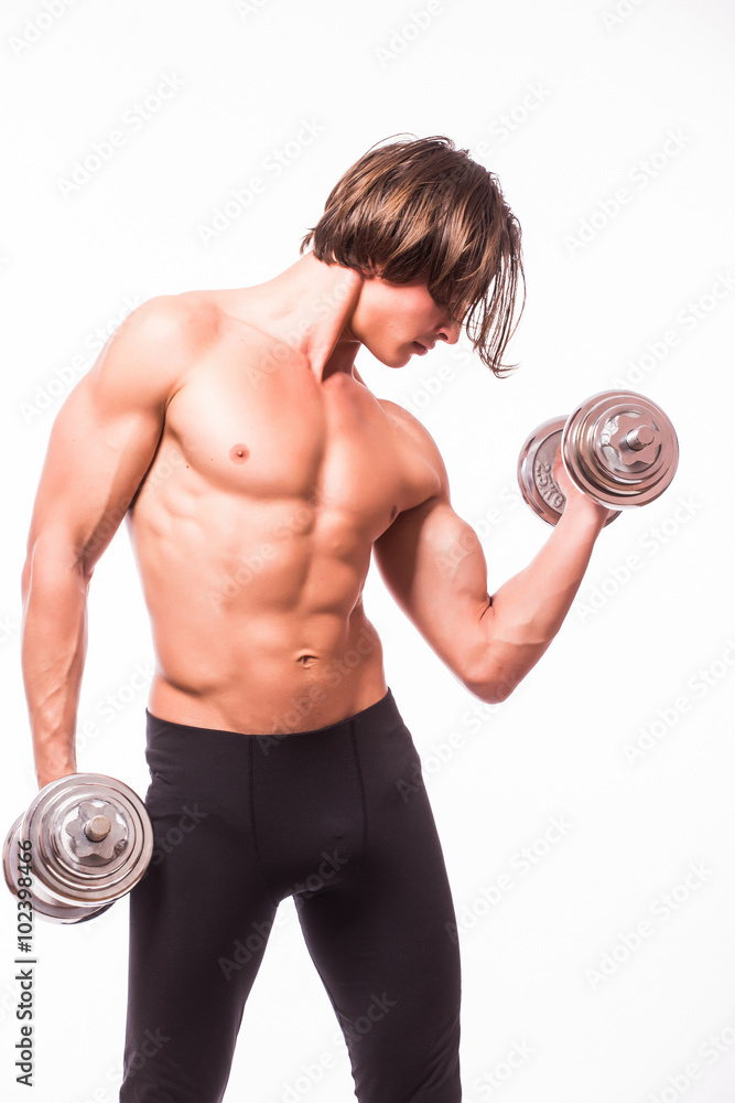 Muscular male athlete is training by lifting dumbbells against white background Muscular male athlete is training by lifting dumbbells against white background