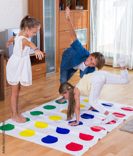 Children playing twister at home. photo