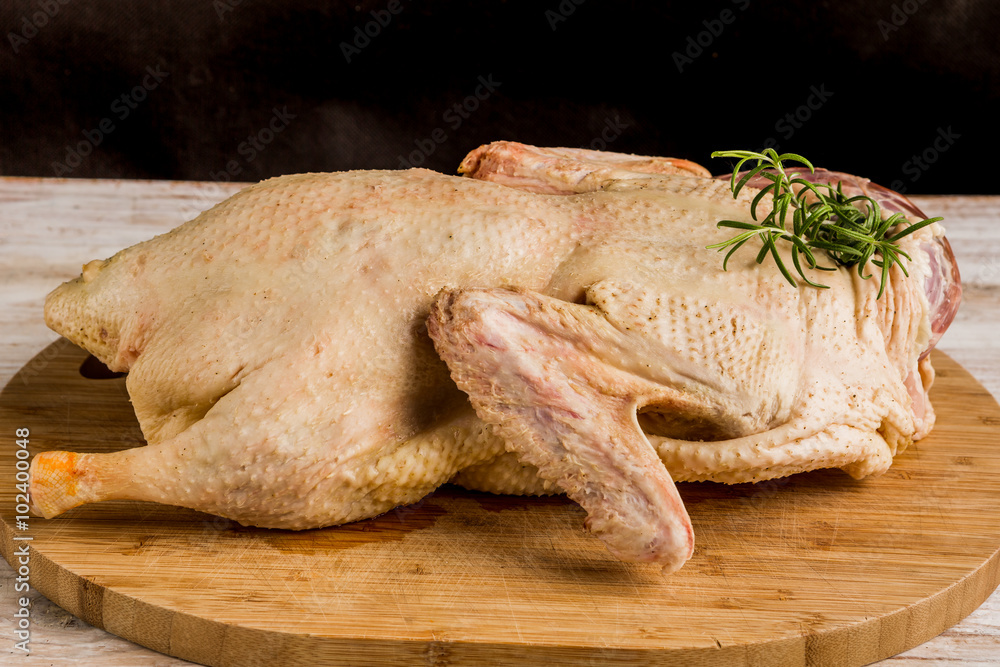 Fresh raw duck carcass on wooden cutting board Fresh raw duck carcass on wooden cutting board