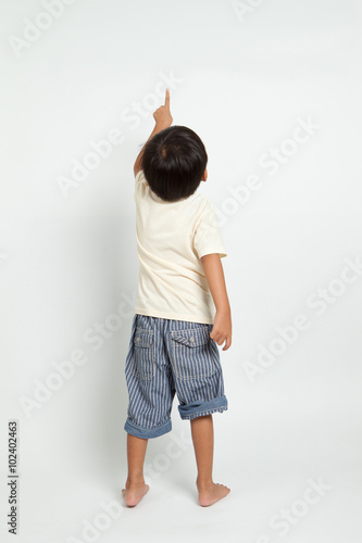 child pointing at wall. Back view. Isolated on white background