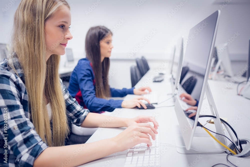 Smiling student working on computer Smiling student working on computer