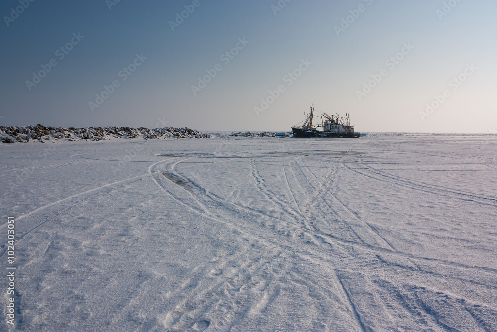 old trawler frozen in the ice