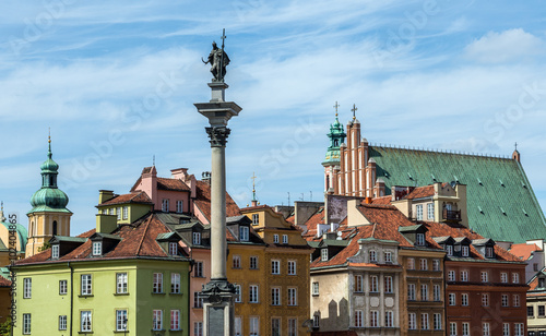 Tenement house and King Sigismund III Vasa Column on the Old Town of Warsaw, Poland photo