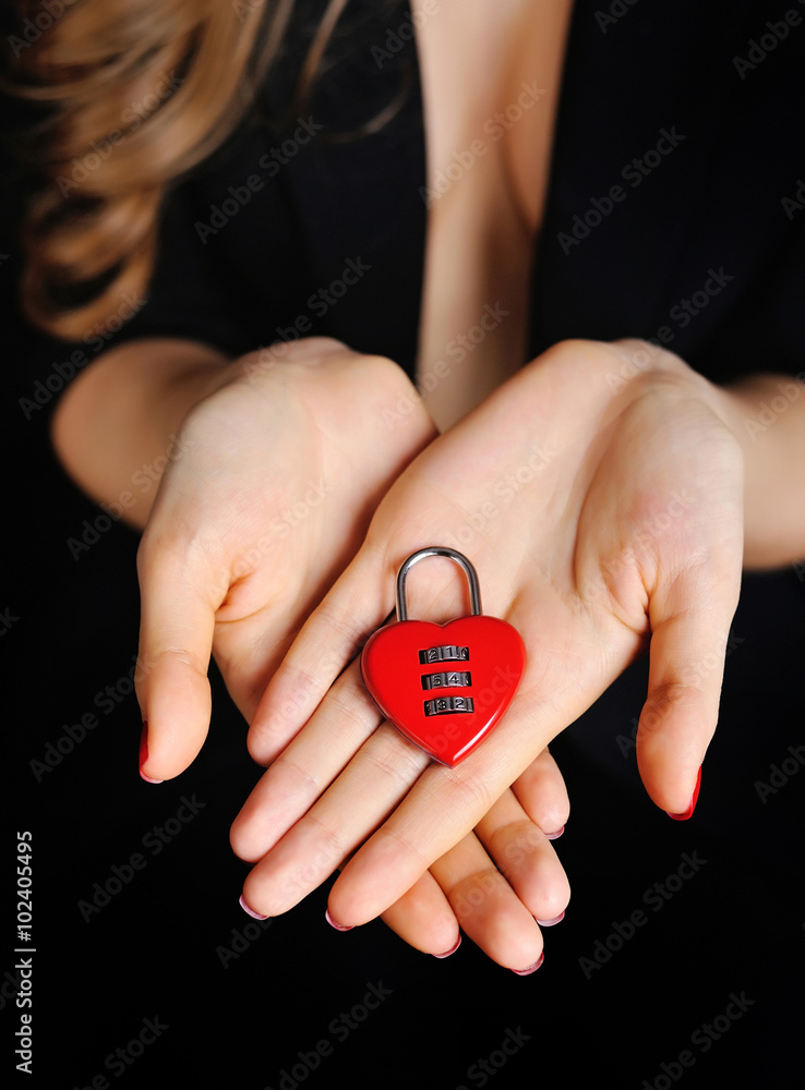 Beautiful girl with padlock heart-shape in hand Beautiful girl with padlock heart-shape in hand