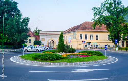 Принти на полотні view of a small roundabout with an ancient poarta schei gate leading to the old town of romanian city brasov