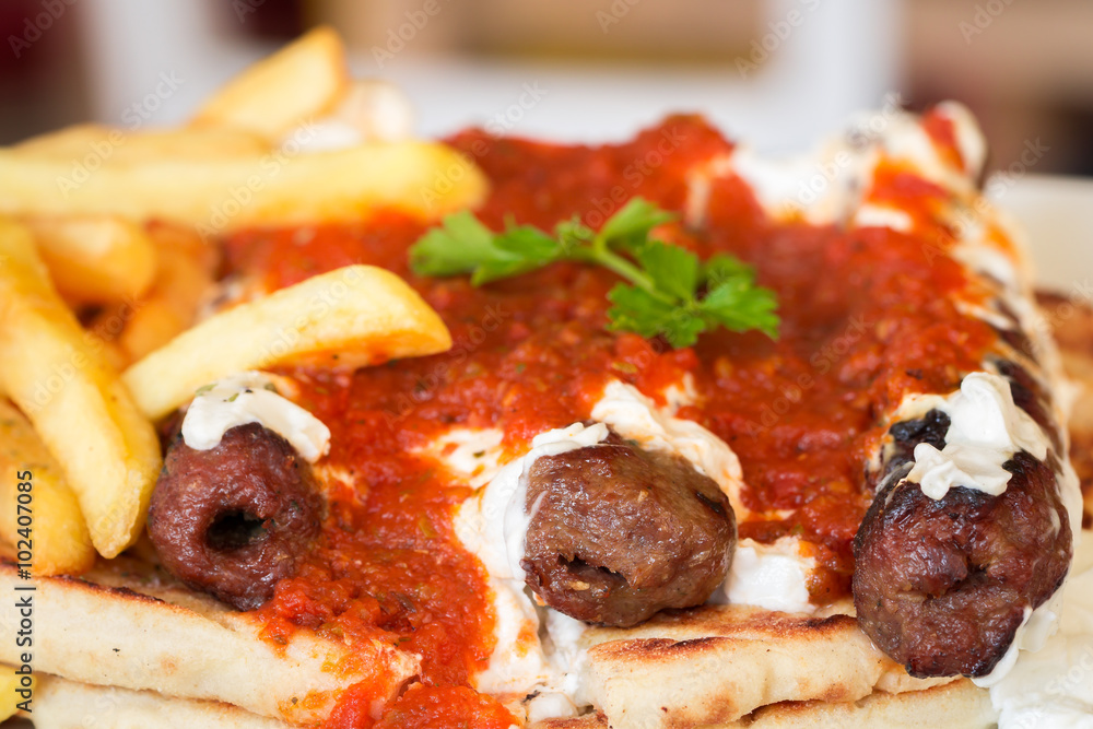 Fried kebab under yogurt sauce and tomato, Greece Athens, national food, traditional Greek cuisine Fried kebab under yogurt sauce and tomato, Greece Athens, national food, traditional Greek cuisine