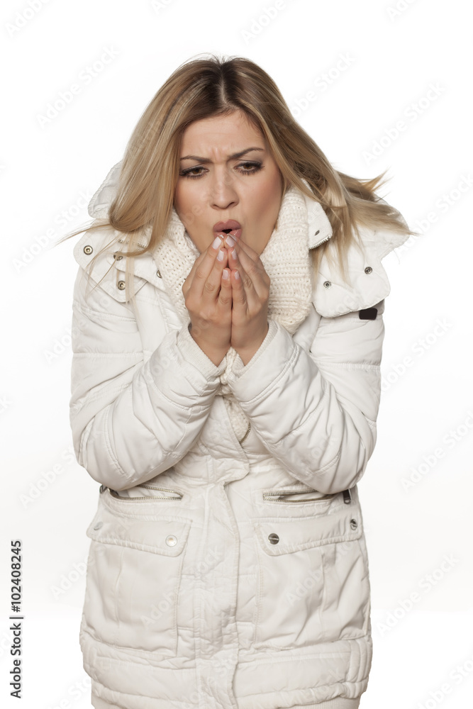 cold young beautiful woman in winter clothes blowing in her hands cold young beautiful woman in winter clothes blowing in her hands
