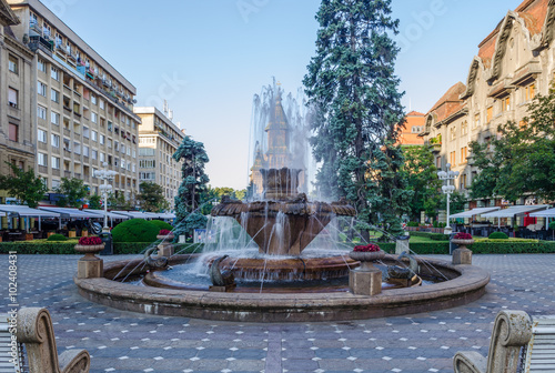 fountain in the middle of victory square - piata victoriei - in romanian timisoara during unrise photo