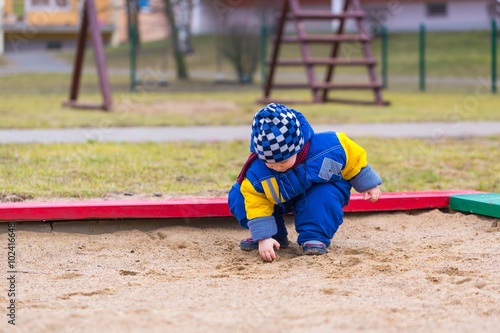 Little boy playing outdoor on city playground © milosz_g