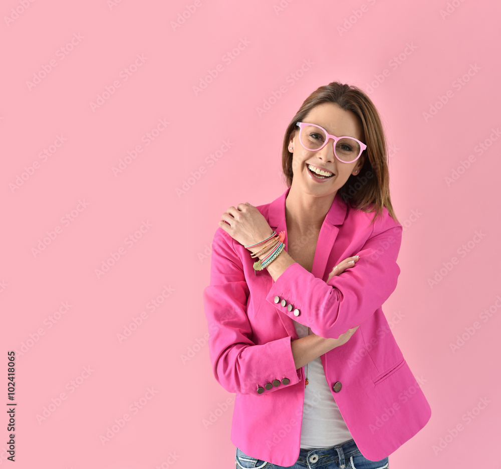 Cheerful girl wearing eyeglasses, pink color