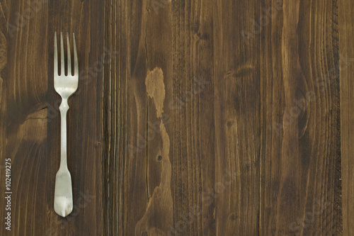 fork on brown wooden background