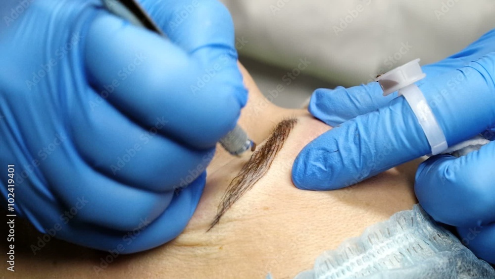 Microblading procedure. Master works with the eyebrows. Semi-permanent make-up. Microblading procedure. Master works with the eyebrows. Semi-permanent make-up.