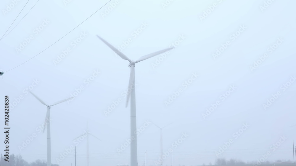 windmills near the road foggy morning. windmills near the road foggy morning.