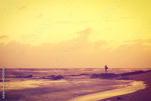 Landscape of sky , sea and beach which has photographer on rock ; Songkhla Thailand ; vintage style