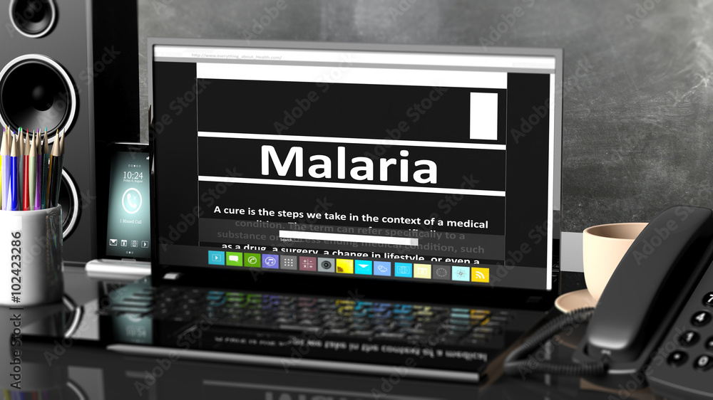 Laptop with Malaria information on screen, on desktop with office objects.