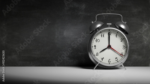 Retro silver alarm clock with blackboard and copy-space