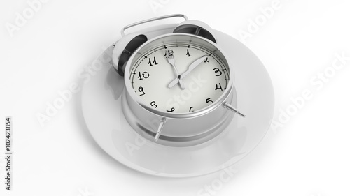 Silver alarm clock with fork and knife pointers on plate, isolated on white background.