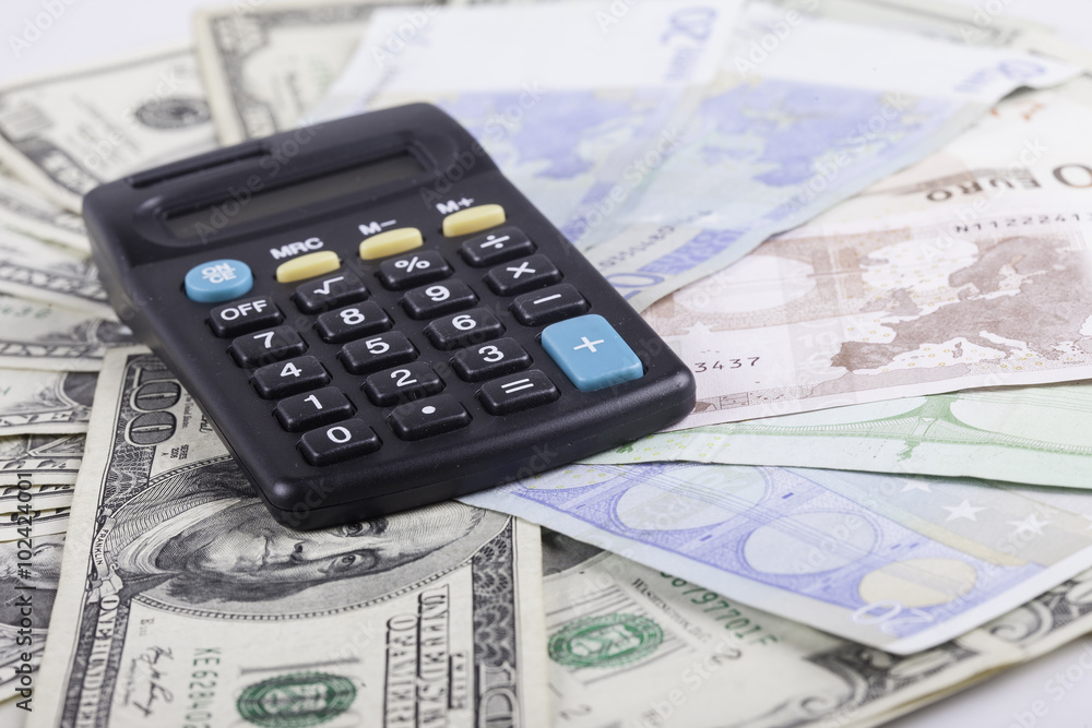 calculator and banknotes of dollars background calculator and banknotes of dollars background